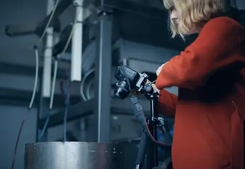 A woman photographing one of the conveyor systems