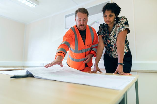 Two engineers looking at papers