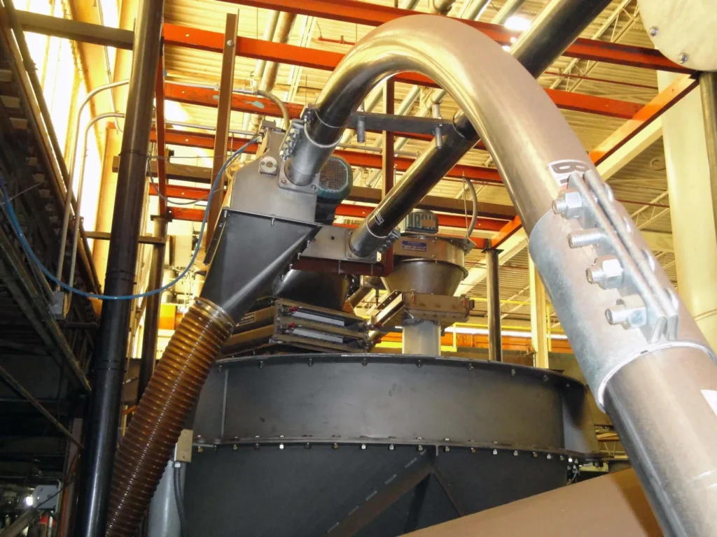 Tubular conveyor outlet in a production facility
