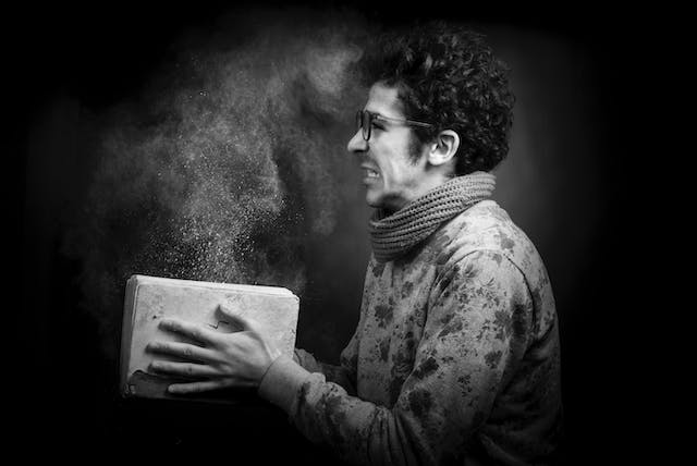 A man inhaling dust