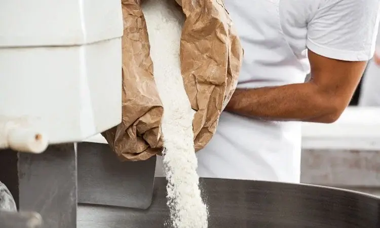 A man pouring flour
