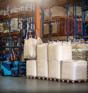 A person handling bulk bags with a forklift