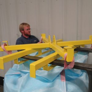 A worker setting the bag on the bag unloader