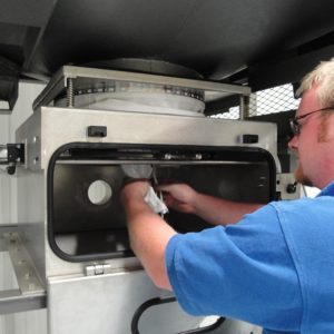 A worker setting the bag on the bag unloader